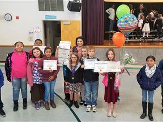 students standing holding their certificates