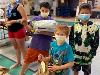 boys with bag of items in hands