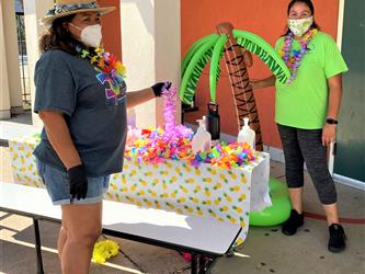 Mrs. Leal and Tanya standing by the check in table