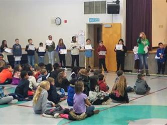 students sitting on the floor during assembly