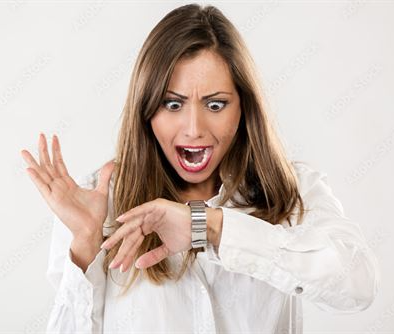 A lady looking at her watch and realizing she is late